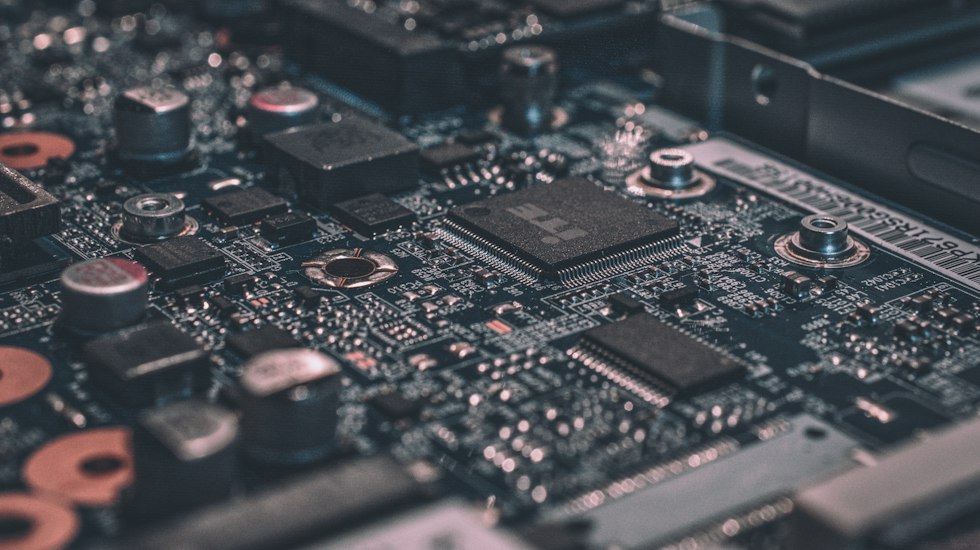 Macro photography of dense circuit board interconnects illustrating the physical limits of semiconductor miniaturization